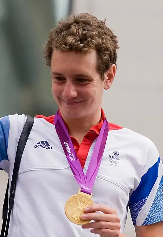 Alistair Brownlee holding Oylympic Medal 2012 London